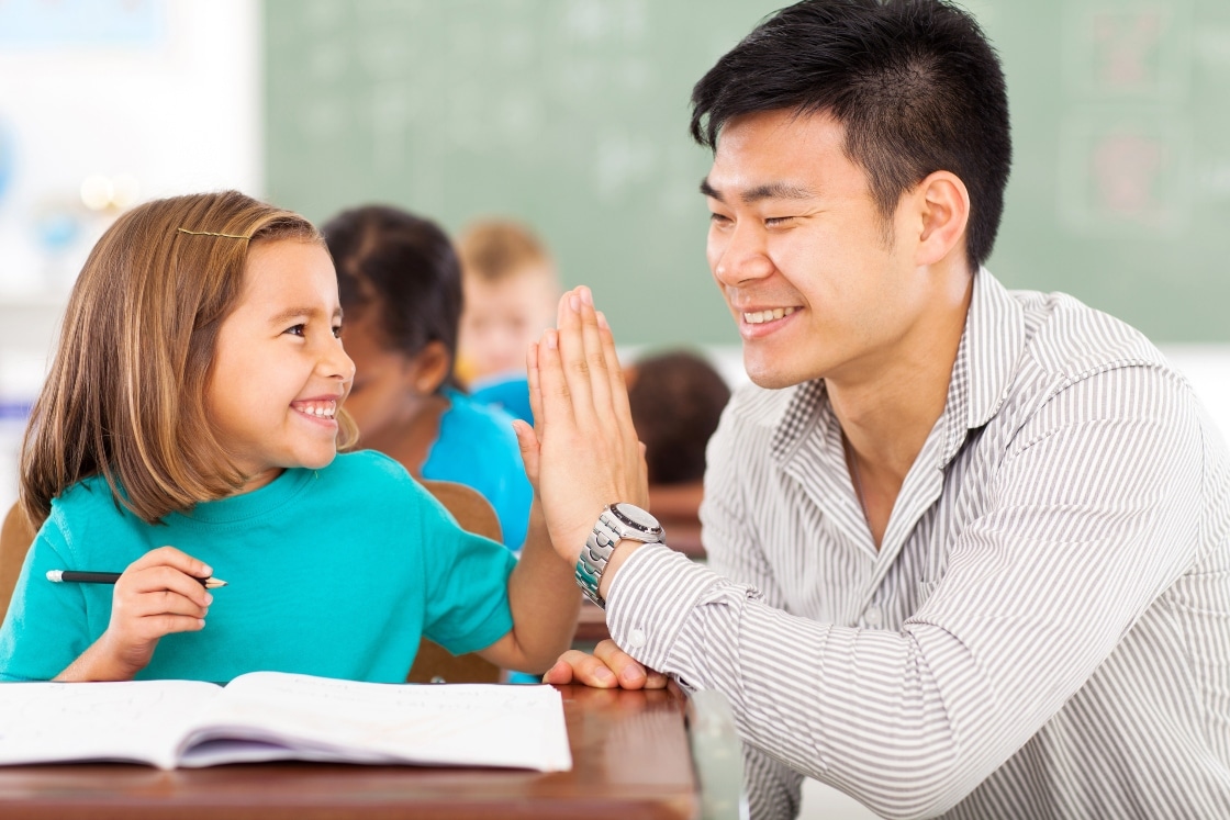 Young Learner hi fiving a teacher 0