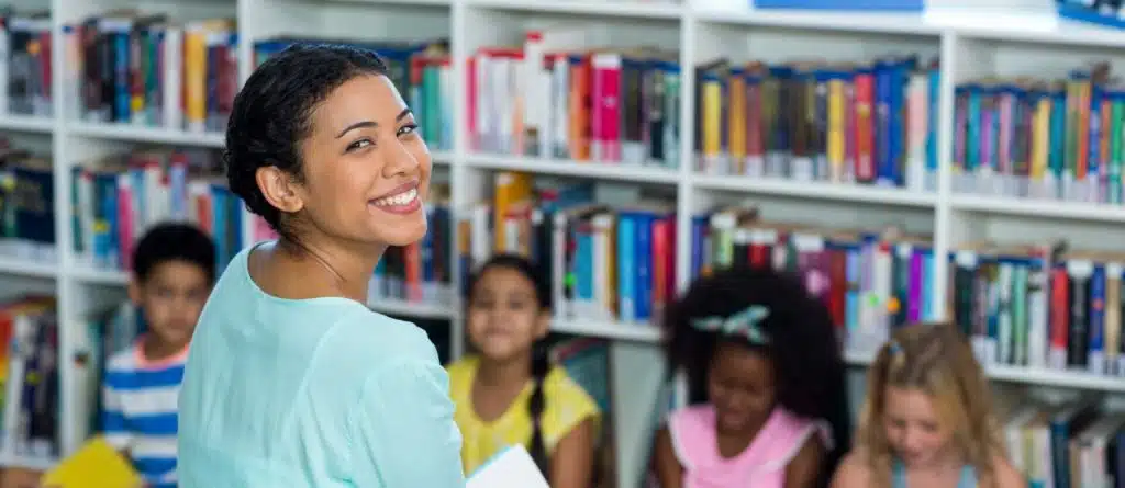 Happy mixed race female teacher with children