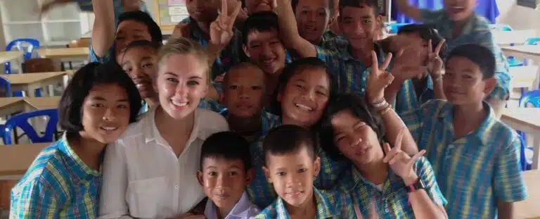 a TEFL teacher with a group of Asian students taking a pciture