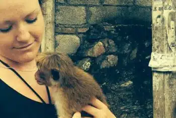 Lizzie Gayton holding a macaque monkey in Sri Lanka