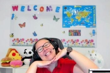 TTA Teacher Kelly at her desk in her online classroom