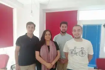 Teacher posing with three students
