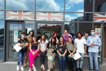 A class photo in front of a school