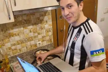 Matt planning for online lessons while cooking in his apartment