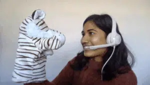 Teacher Tasmika with a zebra puppet