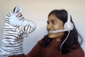 Teacher Tasmika with a zebra puppet