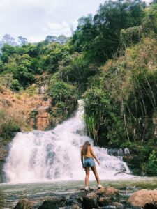 Teacher Taylor looking at a waterfall