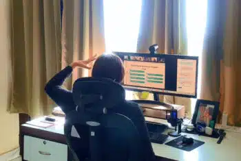 English teacher multitasking during an online lesson