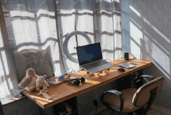 Yasmien's Home teaching setup with webcam, microphone, and laptop