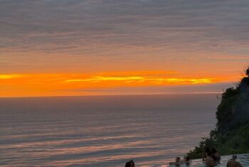 Bali sunset with TEFL teachers relaxing in the pool