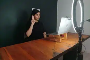 Online teacher using a ring light when recording an introduction video