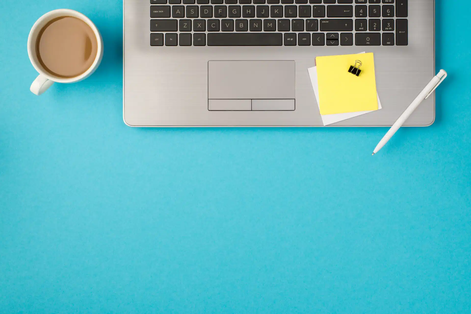 A laptop and a cup of coffee for an online English teacher