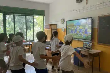 Camp counsellor and students playing a game